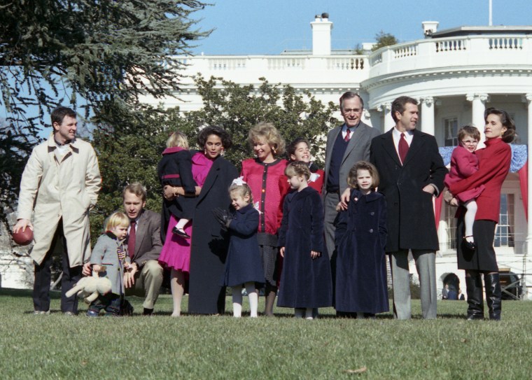 An informal photo of President Bush with some of his children and grandchildren on the White House lawn on Jan 21, 1989.