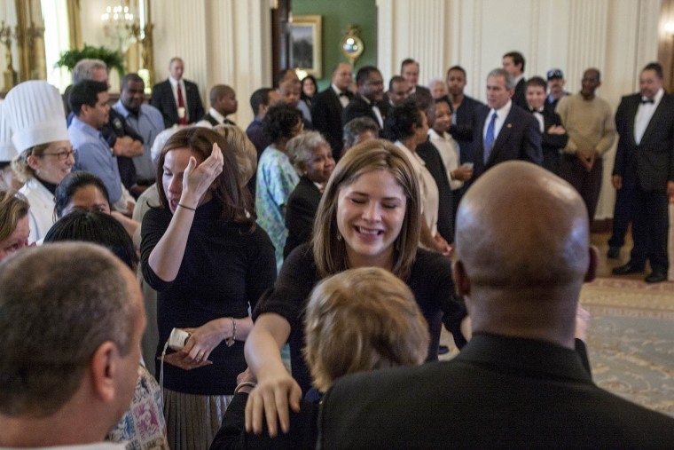 A tearful Barbara Bush and Jenna Bush Hager give hugs with White House staff in the East Room of the White House.