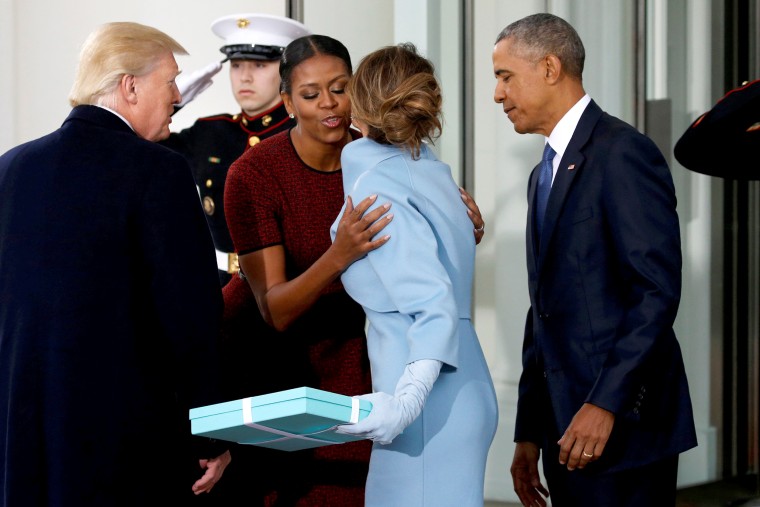 Image: Trump and his wife present a gift to the Obamas as the Trumps arrive for tea before the inauguration at the White House in Washington