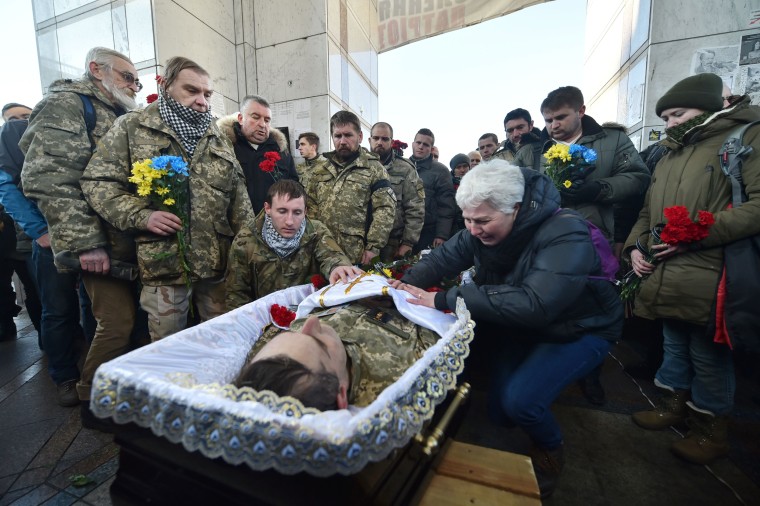 Image: People pay their respects at the coffin of Volodymyr Andreshkiv