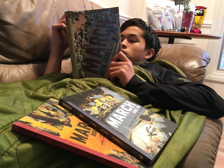Frances Kai-Hwa Wang's son, Little Brother, reading "March," a graphic novel based on Congressman John Lewis' life.
