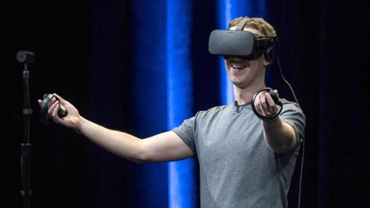 Mark Zuckerberg, chief executive officer and founder of Facebook, demonstrates an Oculus Rift virtual reality headset and Oculus Touch controllers.
