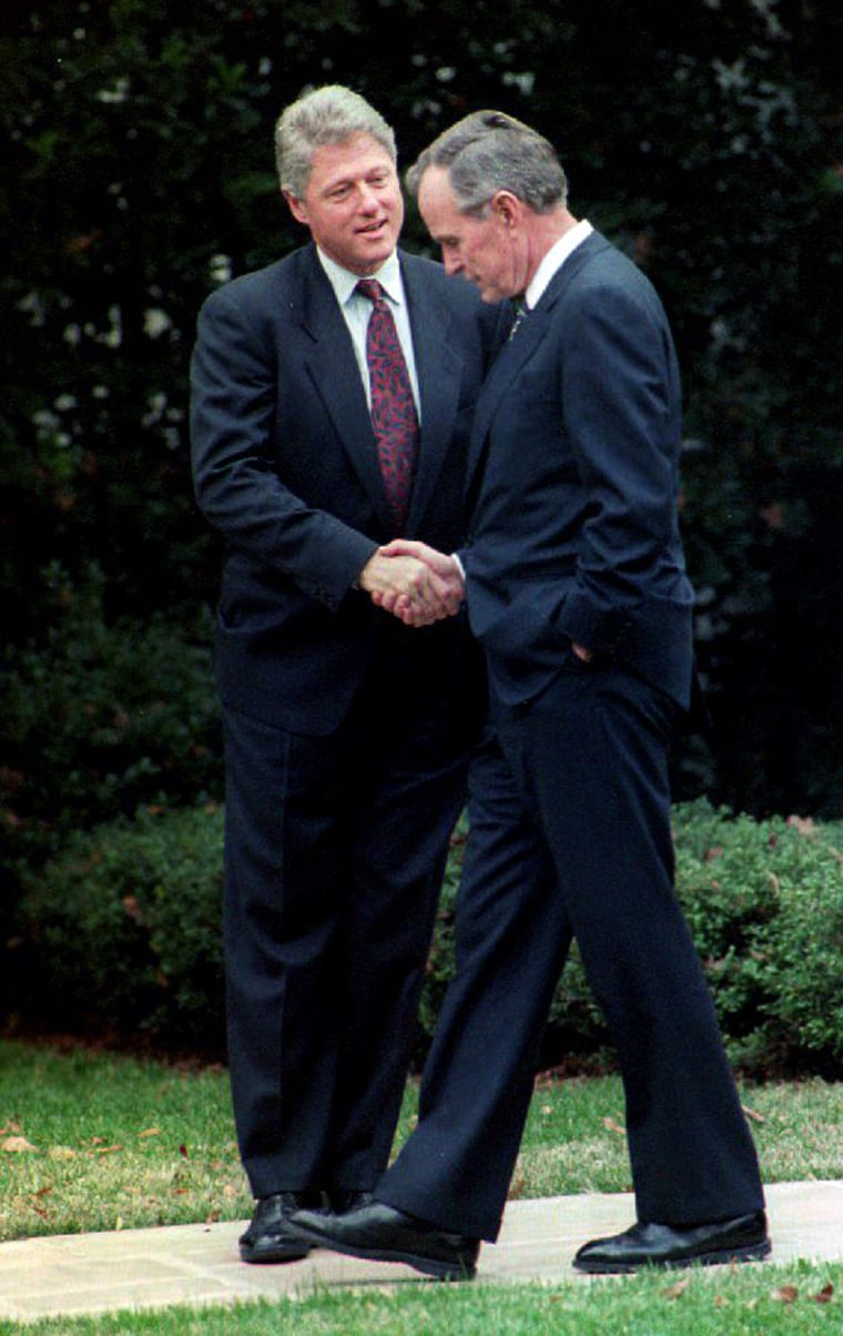 U.S. President George Bush (R) shakes hands with P
