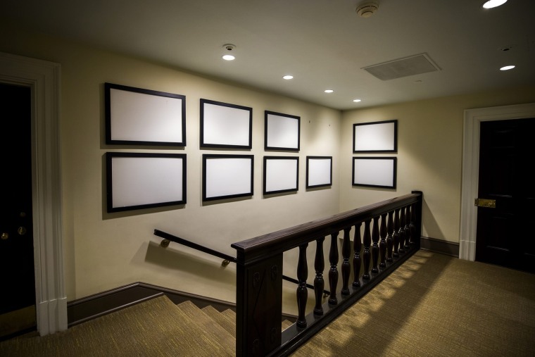 Image: Picture frames that once displayed photographs of President Barack Obama now sit empty in the West Wing of the White House