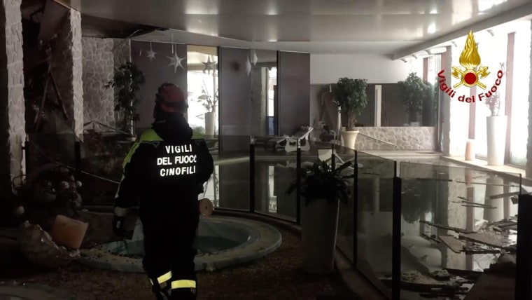 Image: An Italian firefighter walks inside the Hotel Rigopiano after an avalanche