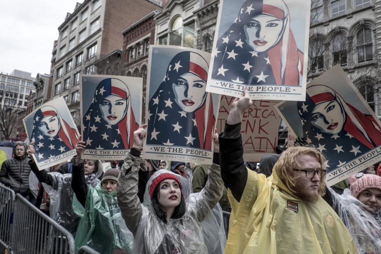 Image: Protesters chant slogans.