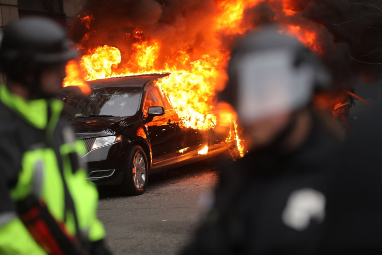 Image: Police and demonstrators clash in downtown Washington, D.C. after a limo was set on fire following the inauguration of President Donald Trump on Jan. 20 in Washington, D.C.