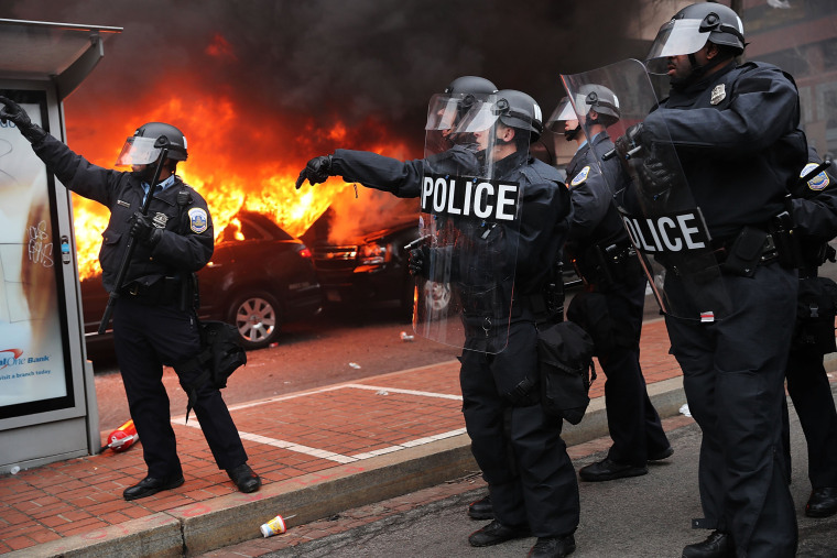 Image: Police and demonstrators clash in downtown Washington, D.C. after a limo was set on fire following the inauguration of President Donald Trump on Jan. 20.