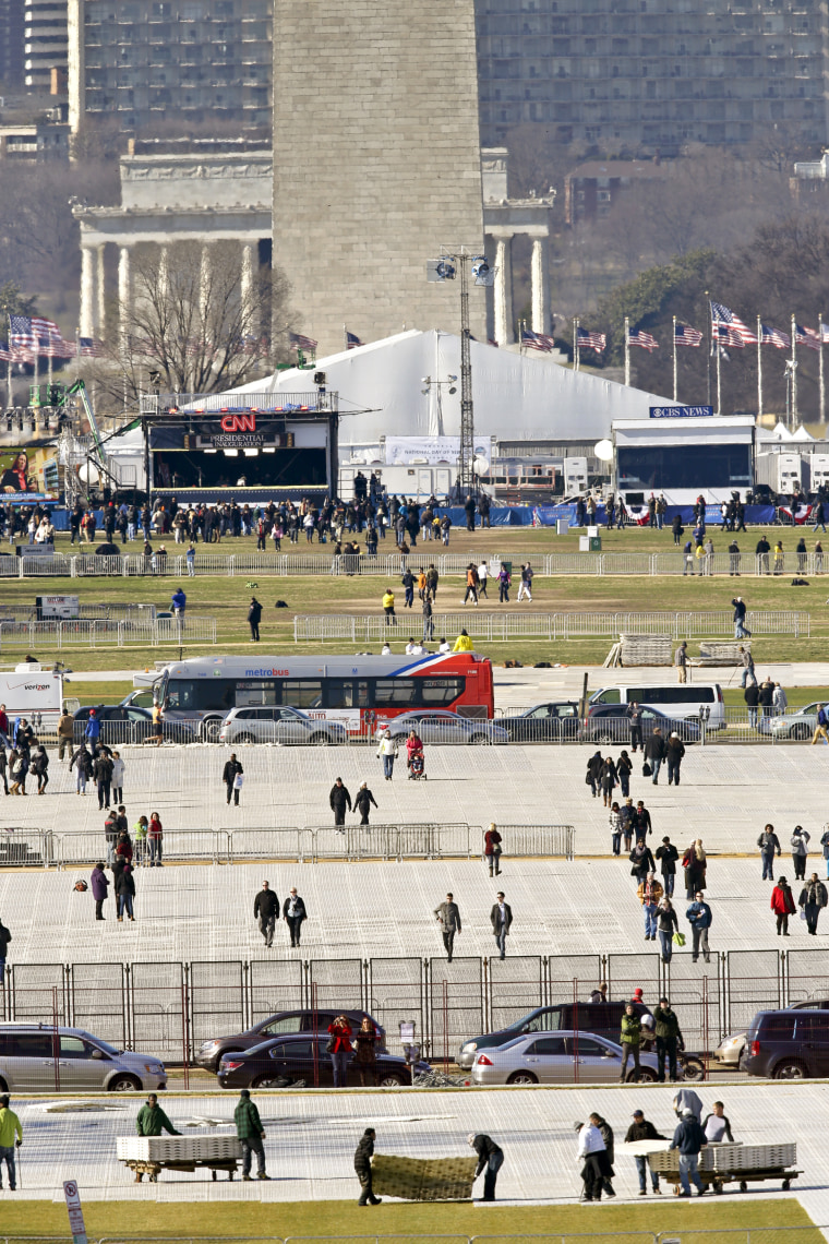 This Jan. 19, 2013 file photo shows crews laying down special mats to protect the lawn on the National Mall for President Barack Obama's inauguration in Washington.