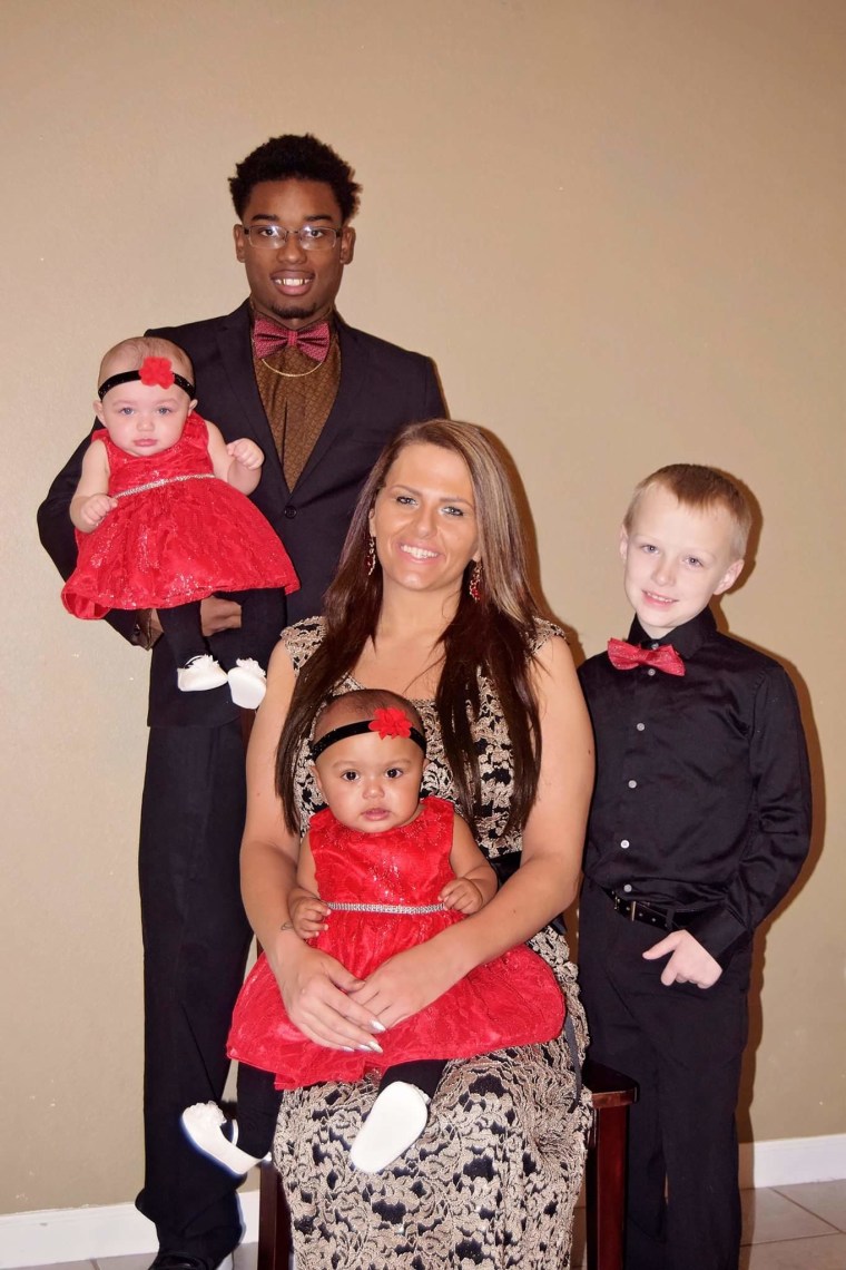 The twins with their parents and older half-brother, Talan.