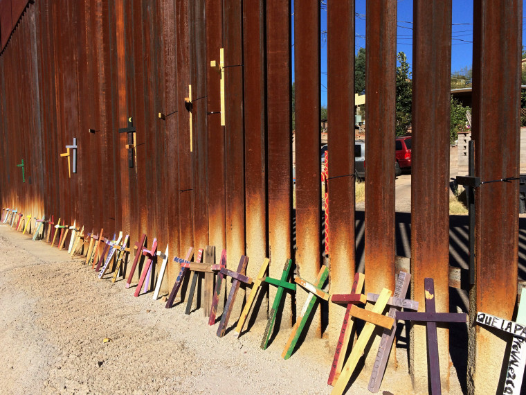 Image: Wooden crosses, in memory of migrants who died crossing to the U.S., lean on the border fence between Mexico and the U.S.