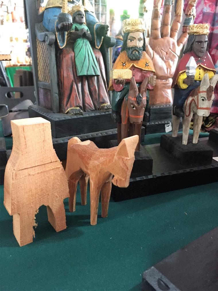 Puerto Rican artisan Jose A. Orta Rivera demonstrates the beginning of his process to make a cedar saint on the left, and the finished product (one of the Three Wise Men) on the right. Arts and crafts is a big part of the Festival de San Sebastian in Old San Juan, P.R.