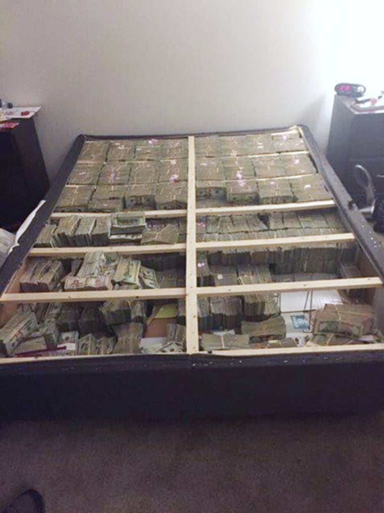 Image: A box spring full of $20 million in cash was seized following the arrest of a Brazilian national
