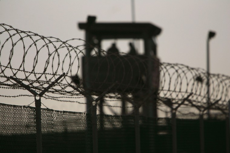 Image: U.S. military guards keep watch over the Camp Delta detention center in Guantanamo Bay in 2006.