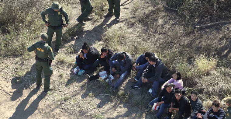 Image: Border Patrol agents watch over immigrants