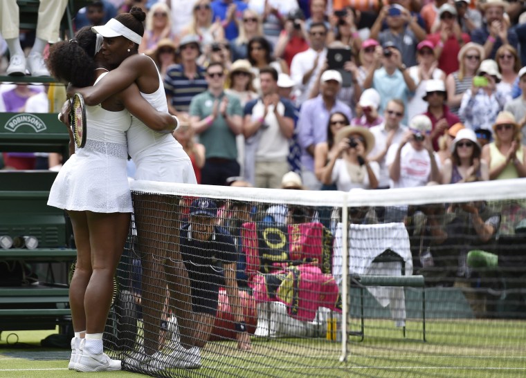 Image: Serena Williams embraces Venus Williams after winning their match at the Wimbledon Tennis Championships in London