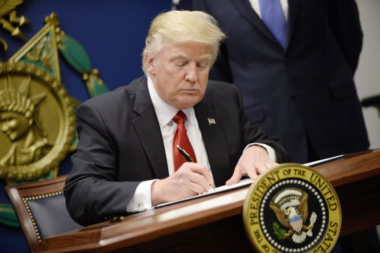 Image: President Donald Trump signs Executive Orders in the Hall of Heroes at the Pentagon in Arlington, Virginia on Jan. 27.