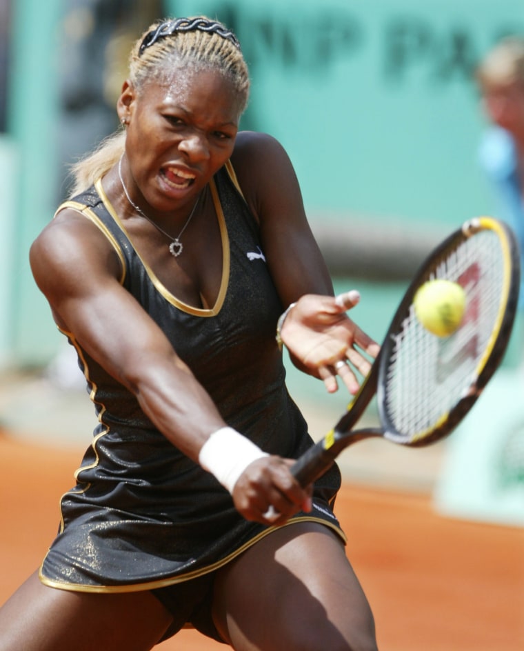 Image: 2002: Serena Williams returns a backhand to her sister Venus during the French Open final match at the Roland Garros stadium on June 8. Serena won the game, which was her first French Open title.
