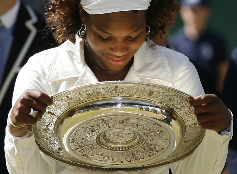 Image: 2009: Serena Williams holds the trophy after winning against her sister Venus in their women's final match of the Wimbledon tennis championships in London on July 4.