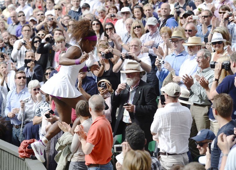 Image: 2012: Serena Williams runs through the crowd to see her father and sister after defeating Agnieszka Radwanska of Poland in their women's final tennis match at the Wimbledon tennis championships in London on July 7.