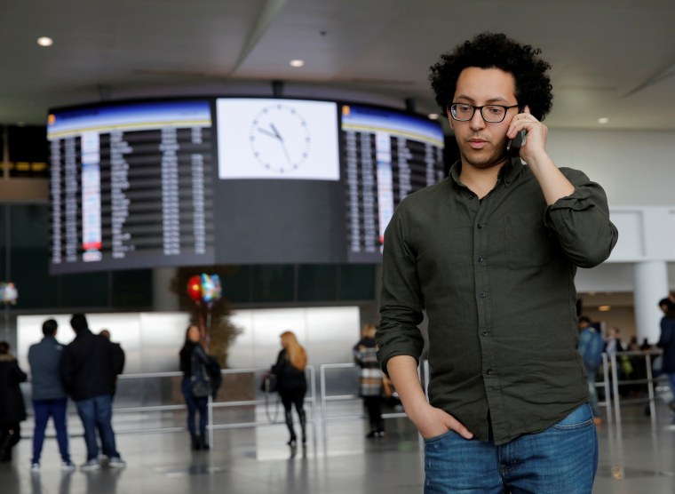Image: Mark Doss, Supervising Attorney for the International Refugee Assistance Project at the Urban Justice Center speaks on his cell phone at John F. Kennedy International Airport in Queens, New York, U.S.