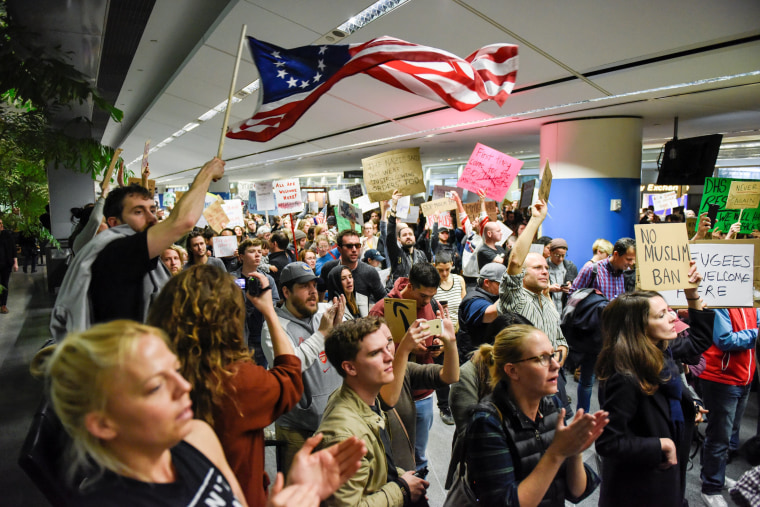 Image: Demonstrators shout slogans during anti-Donald Trump immigration ban protests inside Terminal 4 at San Francisco International Airport in San Francisco