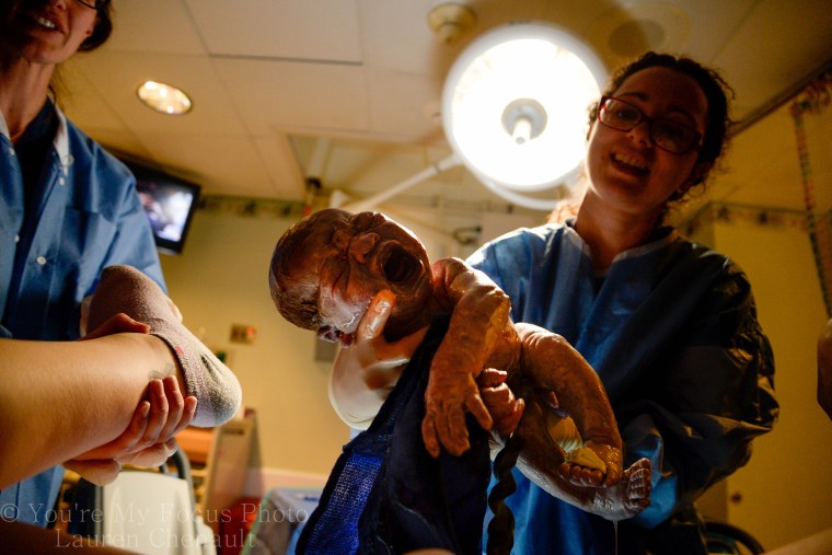 Lauren Chenault, 24, takes pictures of son Kai Arthur during delivery