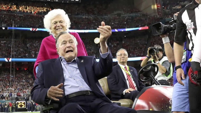 Former U.S. President George H.W. Bush and former first lady Barbara Bush on the field ahead of the start of Super Bowl LI