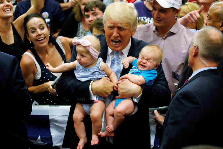 Image: Republican presidential nominee Donald Trump holds babies at a campaign rally in Colorado Springs,
