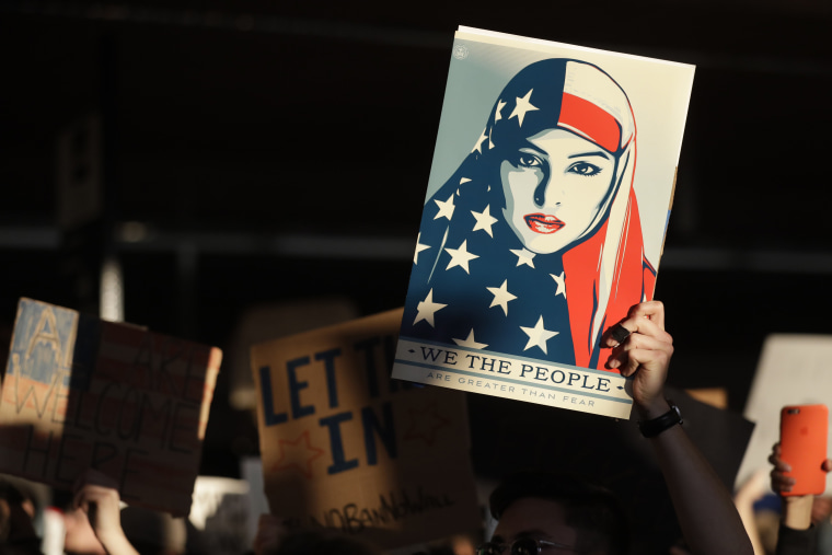 Image: A protester holds a sign at San Francisco International Airport during a demonstration to denounce President Donald Trump's executive order that bars citizens of seven predominantly Muslim-majority countries from entering the U.S. on Jan. 28 in San