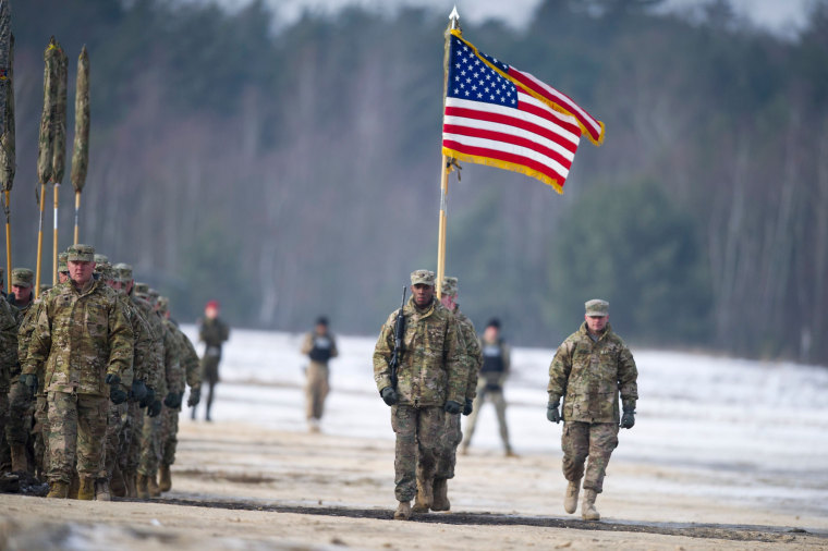 Image: U.S. soldiers march with their flag in Zagan, Poland