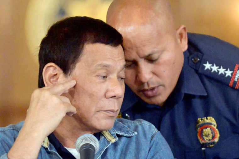 Image: Philippine President Rodrigo Duterte listens as Philippine National Police Director General Ronald Dela Rosa whispers to him, during a late night news conference at the presidential palace in Manila, Philippines, Jan. 29, 2017.