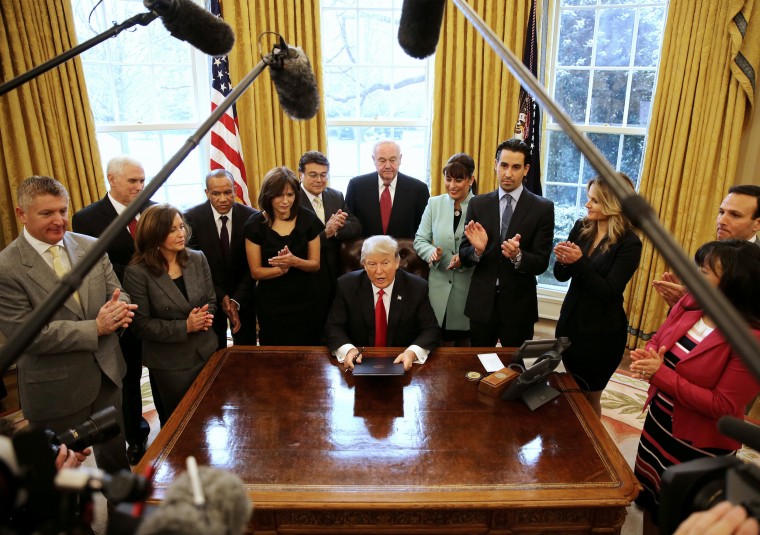 Image: Trump signs an executive order cutting regulations
