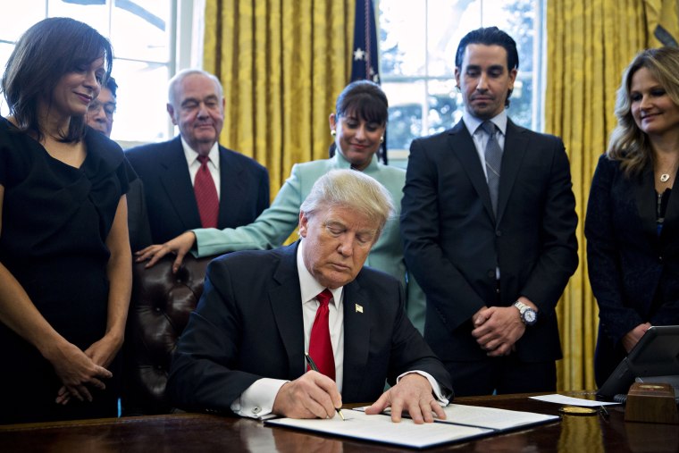 Image: Trump signs an executive order cutting regulations