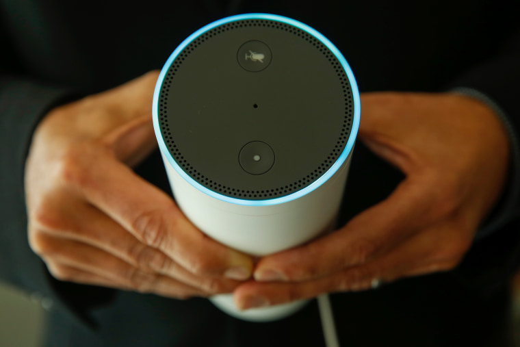 Image: An attendee holds an Echo device during the U.K. launch event for the Amazon device on Sept. 14.