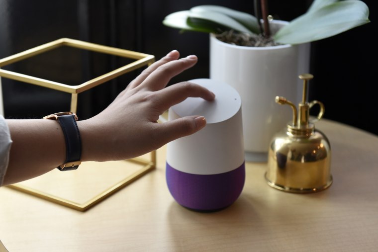 Image: An attendee demonstrates the new Google Inc. Home device during a product launch event in San Francisco, Calif. on Oct. 4.
