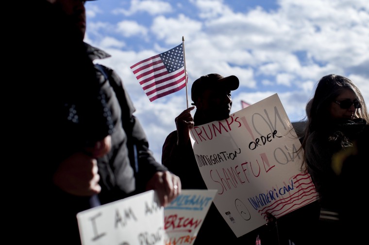 Image: Demonstrators hold signs at Hartsfield-Jackson International Airport during a demonstration on Jan. 29, 2017, in Atlanta.