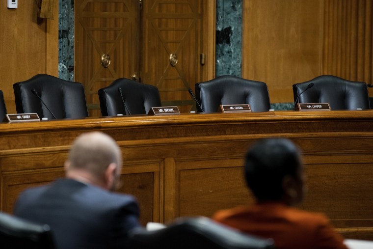 Image: A view of empty Democrat seats during a meeting of the Senate Finance Committee to vote on the nominations of cabinet nominees Tom Price and Steve Mnuchin