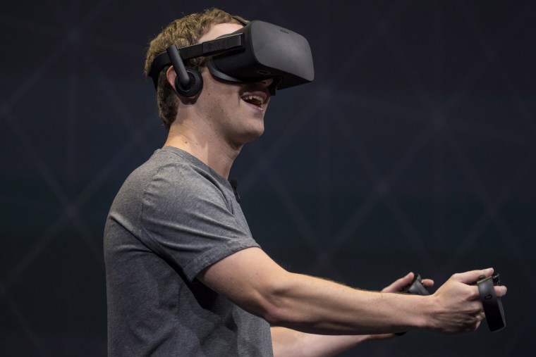 Image: Facebook founder and CEO,Mark Zuckerberg, demonstrates an Oculus Rift virtual reality (VR) headset and Oculus Touch controllers as the gives a demonstration during the Oculus Connect 3 event in San Jose, Calif., on Oct. 6, 2016.