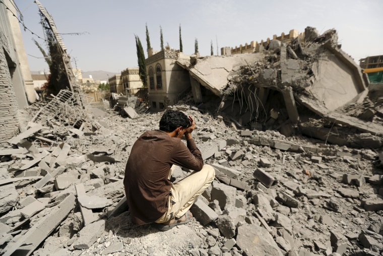 Image: Guard sits on the rubble of the house of Brigadier Fouad al-Emad, an army commander loyal to the Houthis, after air strikes destroyed it in Sanaa, Yemen