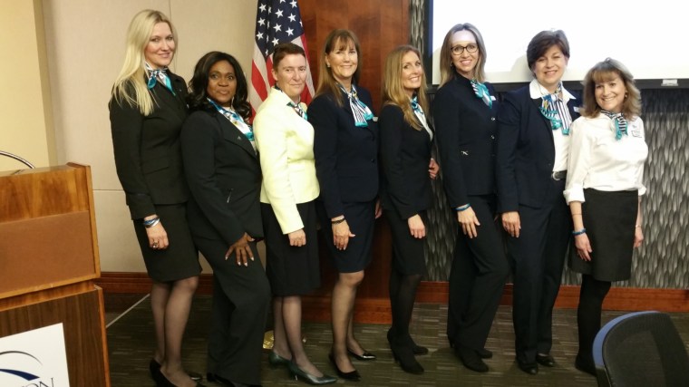 Image: Airline Ambassadors International President Nancy Rivard (fourth from the right) stands with a group of Airline Ambassador trainers in Houston, Texas.