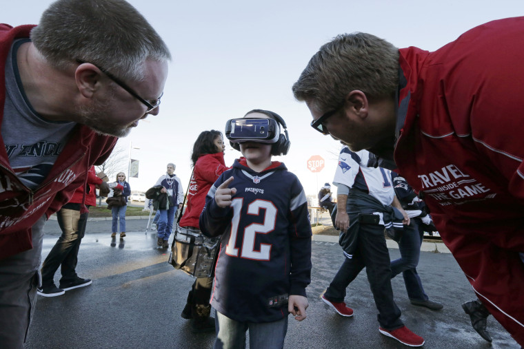 A young boy wears a VR headset while tailgating before an NFL football game between the New England Patriots and the Philadelphia Eagles on Dec. 6, 2015.