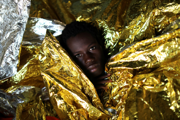 Image: Mamahba, 17, from Guinea, is covered with thermal blankets aboard the former fishing trawler Golfo Azzurro of the Spanish NGO Proactiva Open Arms following a rescue operation near the coasts of Libya in the central Mediterranean Sea on Feb. 3.