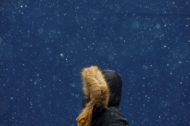 Image: A woman walks in the snow at Times Square in New York City on Jan. 31.