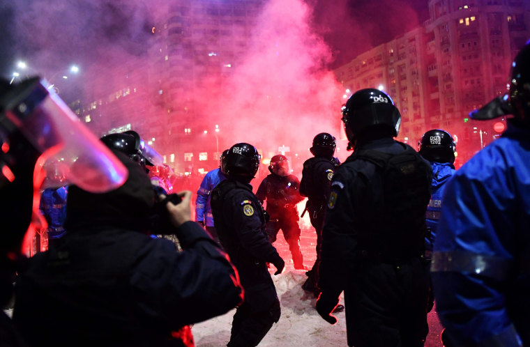 Image: Romanian riot police clash with protesters during a demonstration against controversial decrees to pardon corrupt politicians and decriminalize other offenses in front of the government headquarters in Bucharest on Feb. 1.