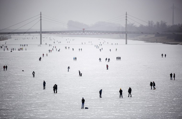 Image: People walk and skate on the frozen New Danube discharge channel in Vienna, Austria on Jan. 29.