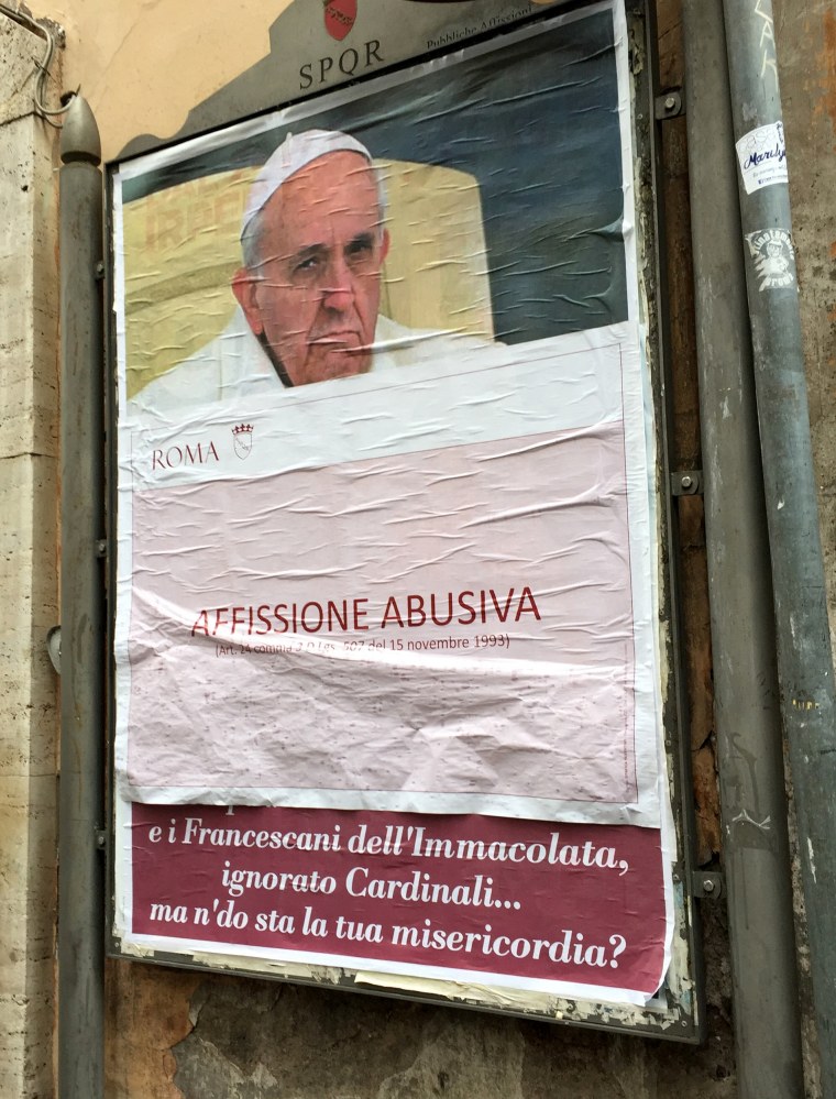 Image: A paper sheet with writing in Italian reading "Illigal Posting" covers an anti-Pope Francis poster in central Rome, Italy, Feb. 4, 2017.