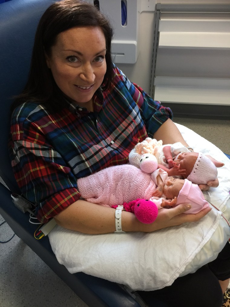 Kat Smith poses with her twin daughters, born at just 28 weeks. 