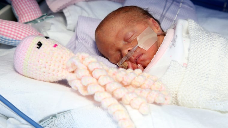 Amber just after she was born with her crochet octopus.