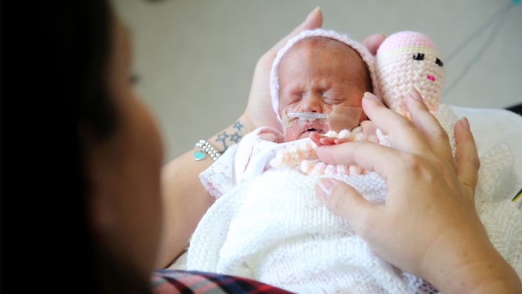 Amber just after she was born with her crochet octopus.